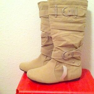 A pair of nude knee high boots