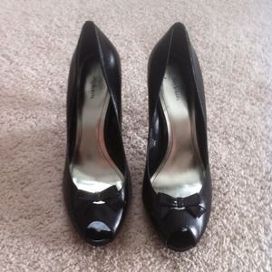 Black peep toe pumps with a bow