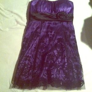 gorgeous purple dress with a black lacing over it