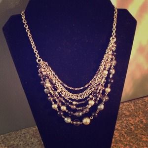 Gold and black necklace. Adjustable length.