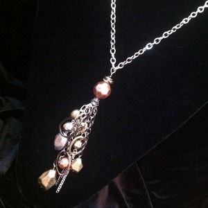 Gold, silver & rose gold tone dangle necklace.