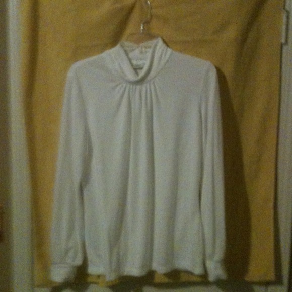 Turtle neck w/ tapered sleeves & gathered at neck.