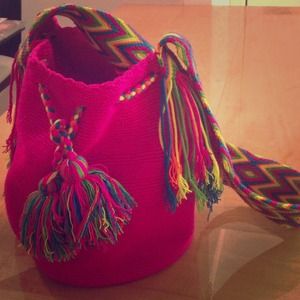 Large pink mochila multicolored strap wth fringe.