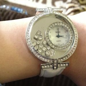 XOXO watch with white band.