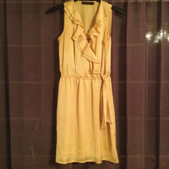 Yellow dress with ruffle neckline.