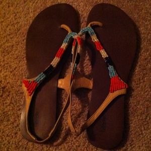 Sandals with blue, orange, black, and white beads.
