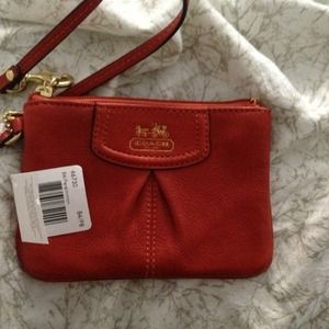 Small leather coach wristlet in persimmon