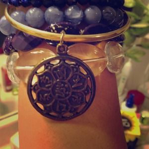 Gold bangle with an ornate charm