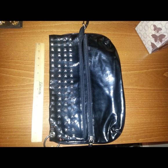 Black studded, flip open, two pocket clutch.
