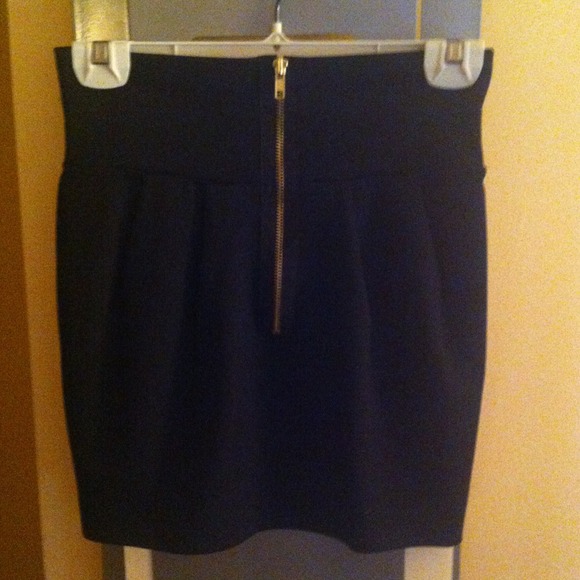 High waisted Black mini with gold zipper.