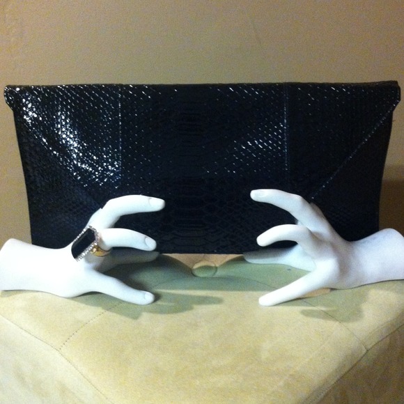 Snakeskin print and feel oversized hand clutch.
