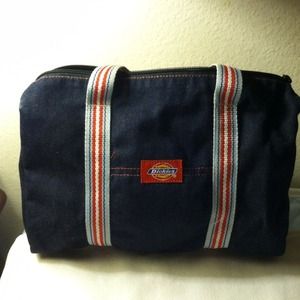 Denim blue Dickies bag with striped handles.