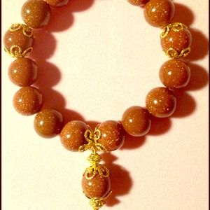 Unique goldstone bracelet with charm.