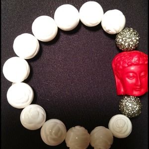 White polished coral bracelet with buddha charm.