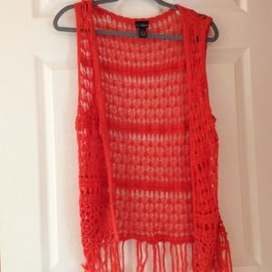 Orange crochet vest with fringe.