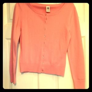 Soft light pink cardigan.