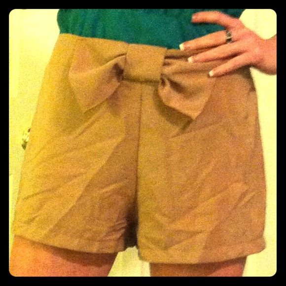Adorable tan shorts finished with a bow!