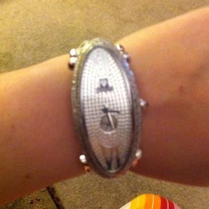 Rayalty watch with changeable pink strap.