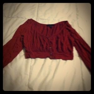 Red cropped cardigan with quarter length sleeves.
