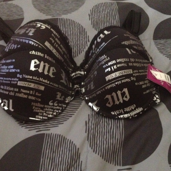 SOLD......2 black newspaper print Bras