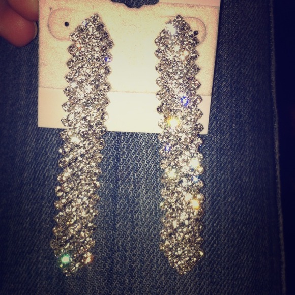 Dangling diamond earrings.