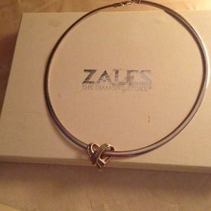 Diamond heart on reversable white gold/gold chain.