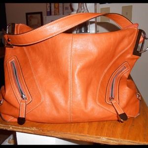 Orange hobo bag with silver hardware and zippers