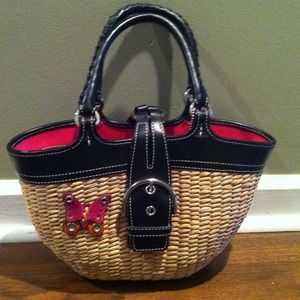 Straw Coach purse with butterfly on outside.