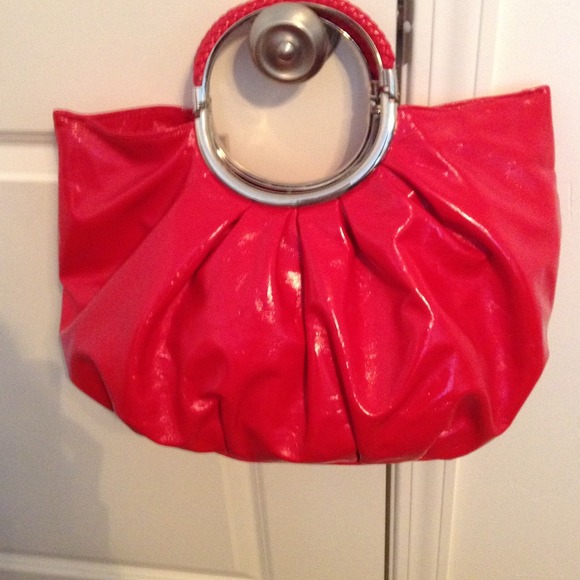 Red hand bag with ring handle.
