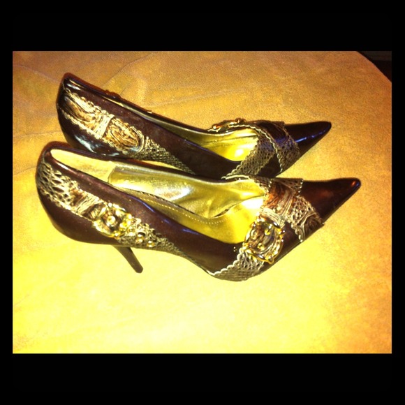 Dark brown pointed stilettos with gold buckles