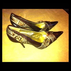 Dark brown pointed stilettos with gold buckles