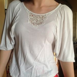 Small white shirt with embroidered neckline.