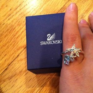 A gorgeous silver starfish ring with jewels on it.