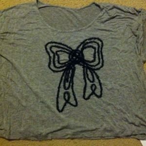 Grey shirt and a black bow design.