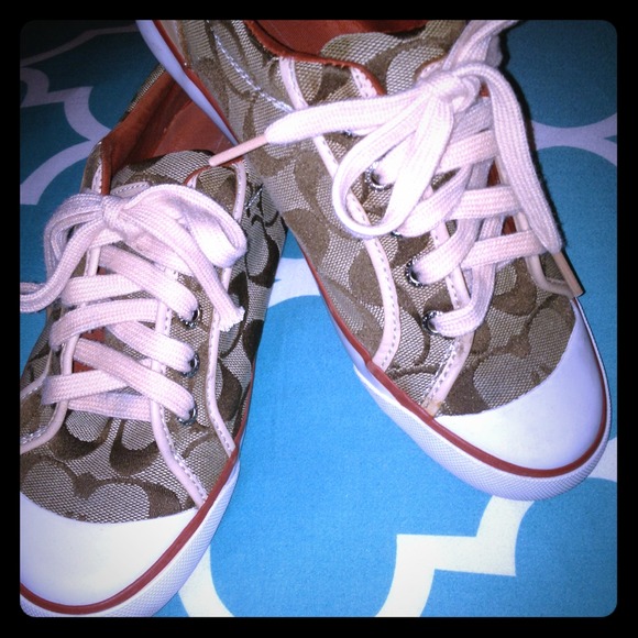Coach logo tennis shoes.