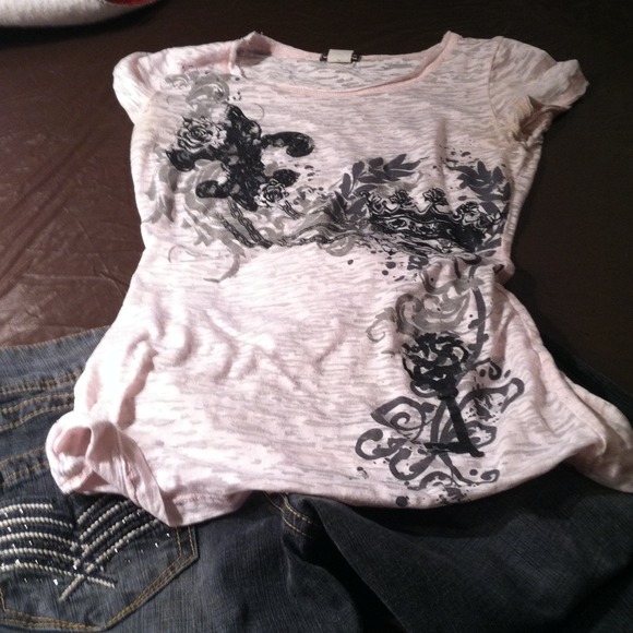 Light pinkish shirt with black embellishments