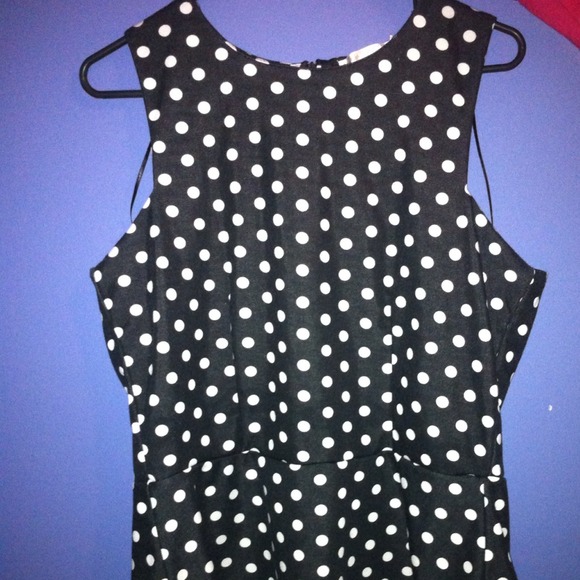 A black shirt with white polka dots that flare out