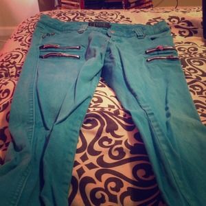 Vibrant blue Trip jeans with four black zippers.