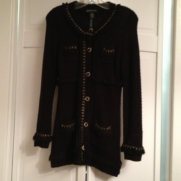 Long black sweater with gold trim and details