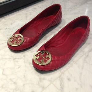 Tory Burch red Reva flats with gold emblem.