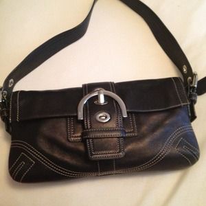 Black leather Coach bag with big silver buckle.