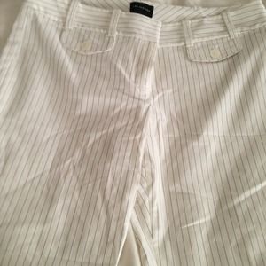 Cream colored dress shorts long.