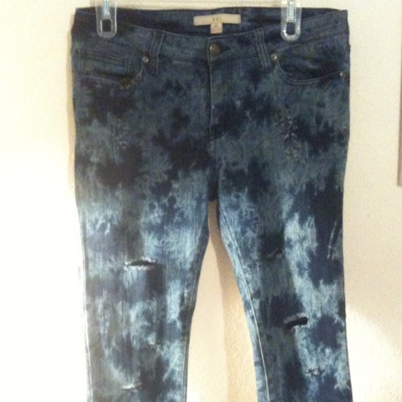 Blue tie dyed pants with several holes and rips