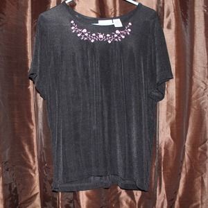 Black top with pink embroidery.