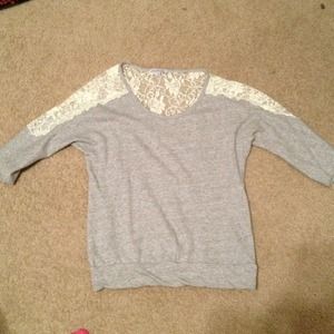 Gray 3 quarter length shirt with lace inset.