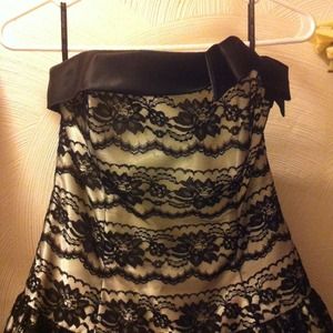 Strapless knee-length lace dress. Bow accent! :)