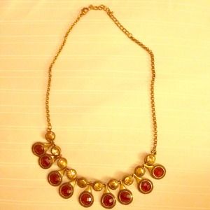 Gold and red necklace.