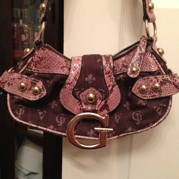 Guess purse with pink snake skin detail.