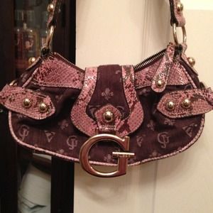 Guess purse with pink snake skin detail.