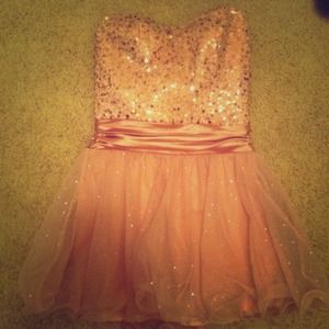 Pink sequence and glitter strapless dress.